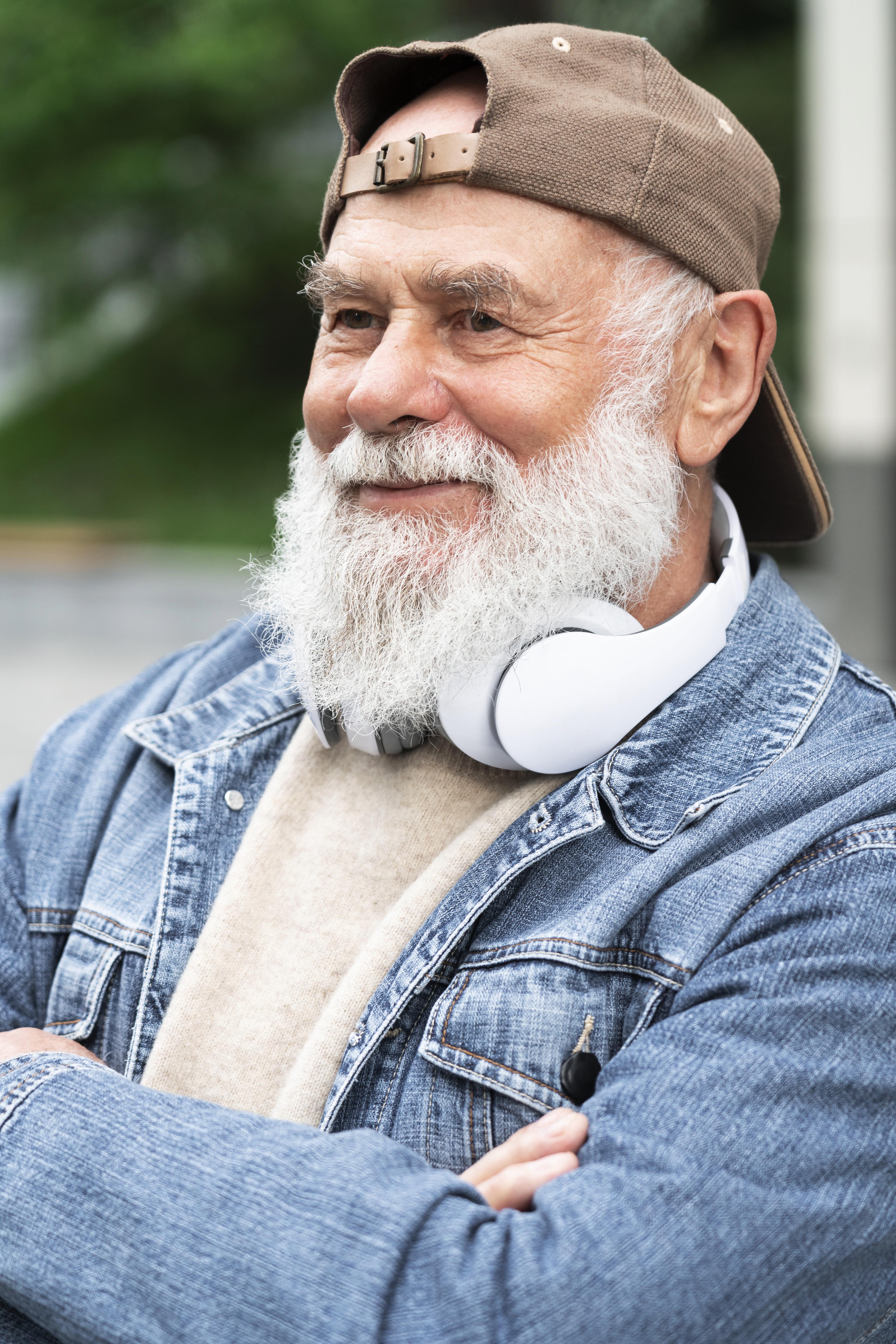 Older man listening to music outdoors